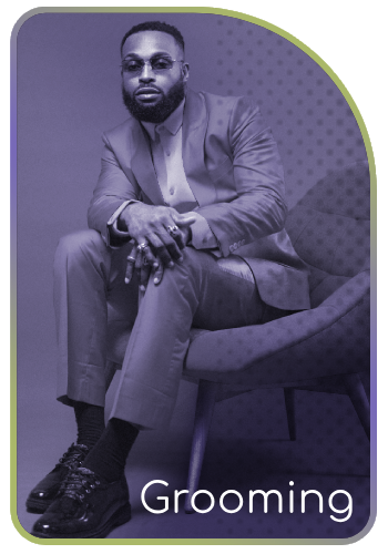 Man in a suit seated confidently, representing the Grooming category.