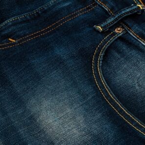 Close-up of blue denim jeans texture and stitching – casual guys spring outfits
