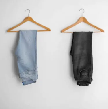 Light wash and dark wash jeans folded on hangers – guys spring outfit essentials