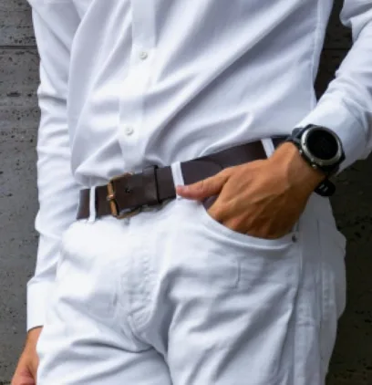Close-up of a man wearing a white shirt and white pants with brown belt – spring outfit for men