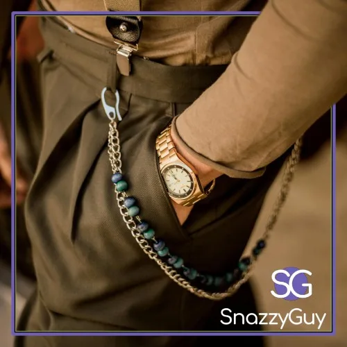 Close-up of a smart casual outfit with pleated trousers, gold watch, suspenders, and chain accessory