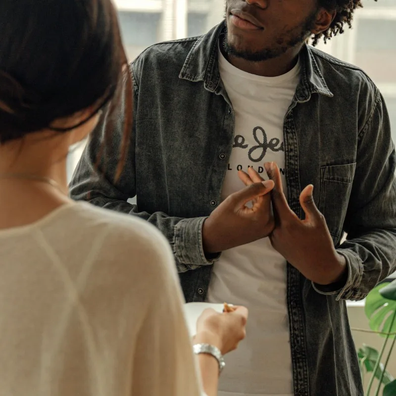 Man wearing a graphic tee layered with a denim shirt – relaxed smart casual outfit