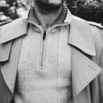 Man wearing a knit zip sweater under a trench coat – layered guys spring outfit