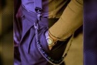 Close-up of men's casual outfit with chain accessory, watch, and suspenders – casual wear for men