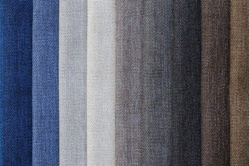 Assorted fabric swatches in neutral tones – men's style tips on color matching