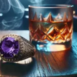 Vintage-style men’s ring with a large purple gemstone beside a glass of whiskey on a wooden table.