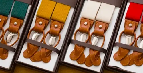 leather suspenders (2) A display of colorful leather suspenders in gift boxes, featuring brown leather accents and metal clips.