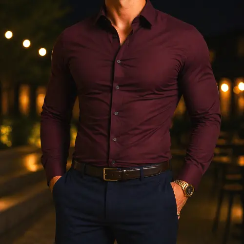 Man wearing a tight burgundy long sleeve button-up shirt with blue pants showing an overly snug fit