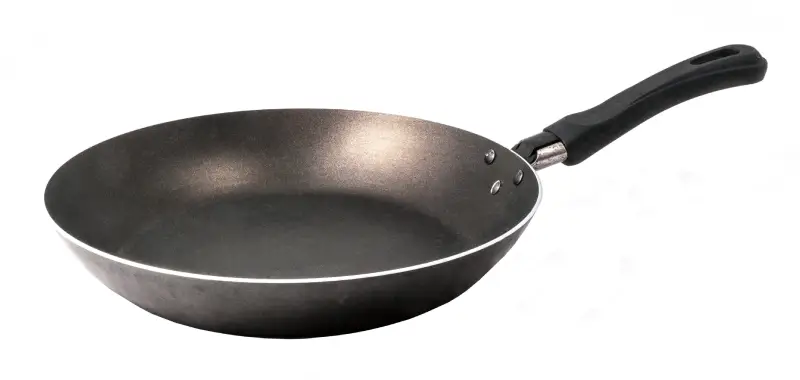 Black nonstick frying pan with a curved edge, shown as a lightweight option sometimes used as the Best Pan for Steak.