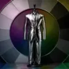 Metallic silver suit displayed on a mannequin in front of a circular monochrome color wheel.