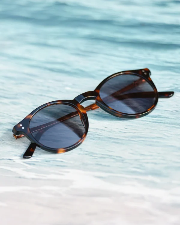 Tortoiseshell round sunglasses with dark lenses styled as Dark Academia Accessories.