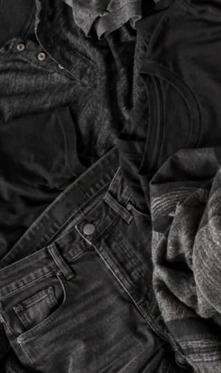 Black jeans, T-shirts, henley shirts, and knitwear showing different textures for all black outfits.