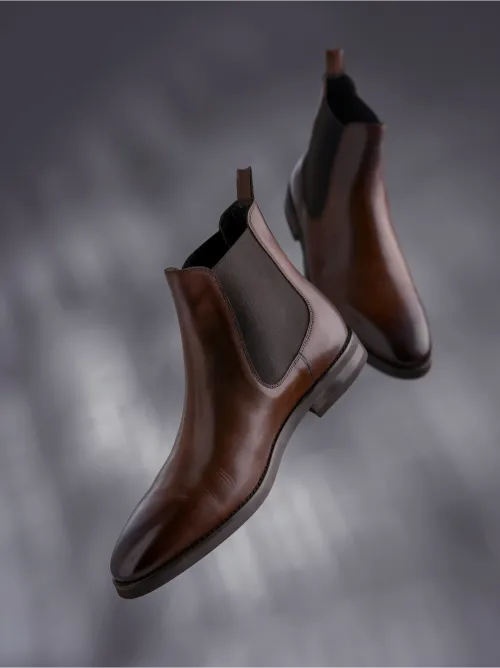 Brown Chelsea boots shown among classic types of men's shoes.