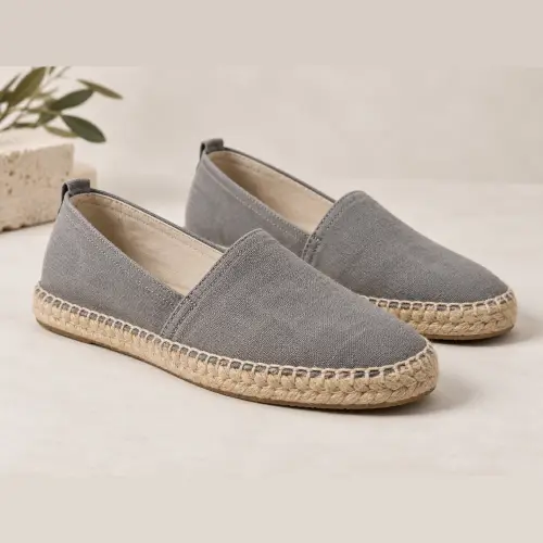 Gray canvas espadrilles shown among casual types of men's shoes.