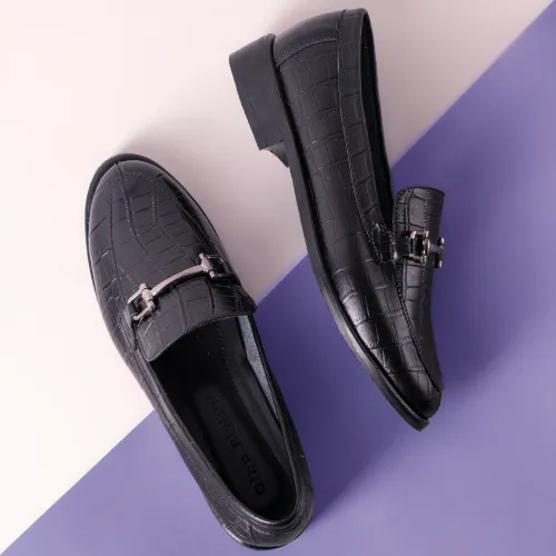 Black horsebit loafers shown among classic types of men's shoes.