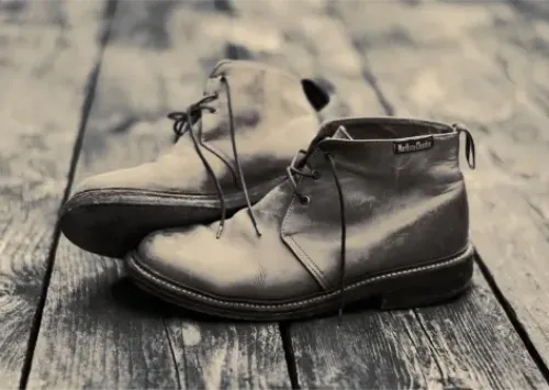 Gray leather desert boots shown among classic types of men's shoes.