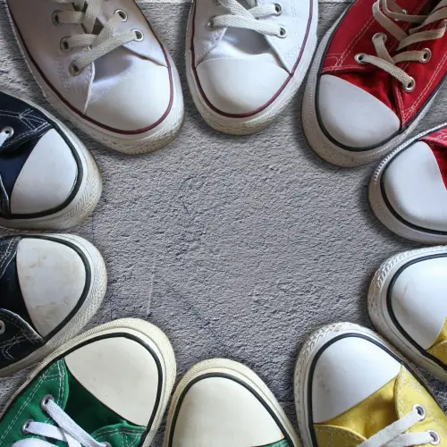 Colorful canvas sneakers shown among casual types of men's shoes.