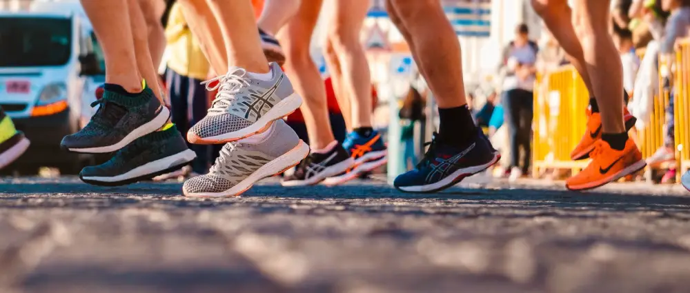 Runners wearing athletic sneakers shown among performance types of men's shoes.