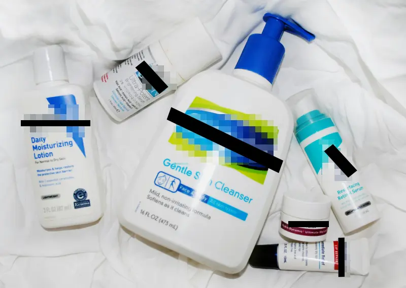 Assorted skincare products with brand names obscured for a visual joke about copyright