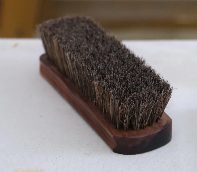 Suede brush with dense bristles used to restore the nap of suede shoes after they get wet.